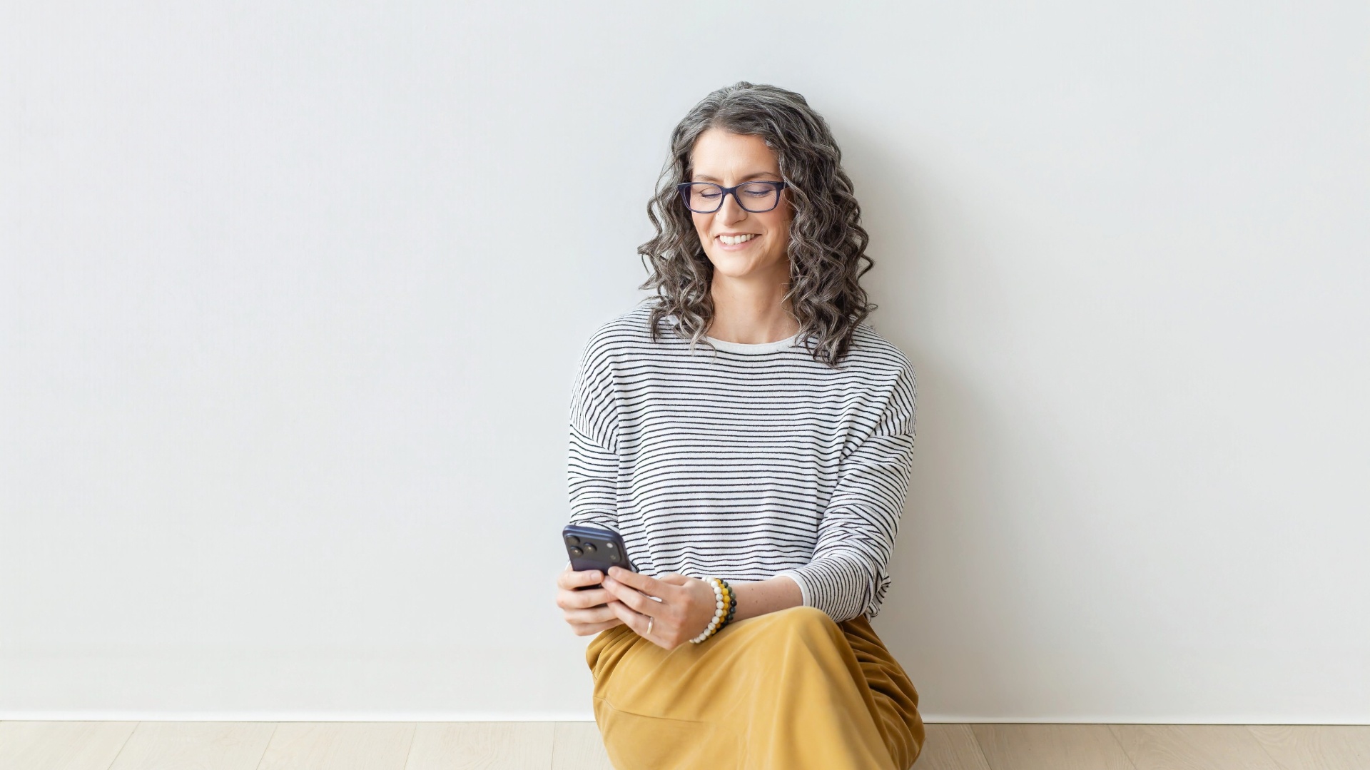 Maria smiling at her phone